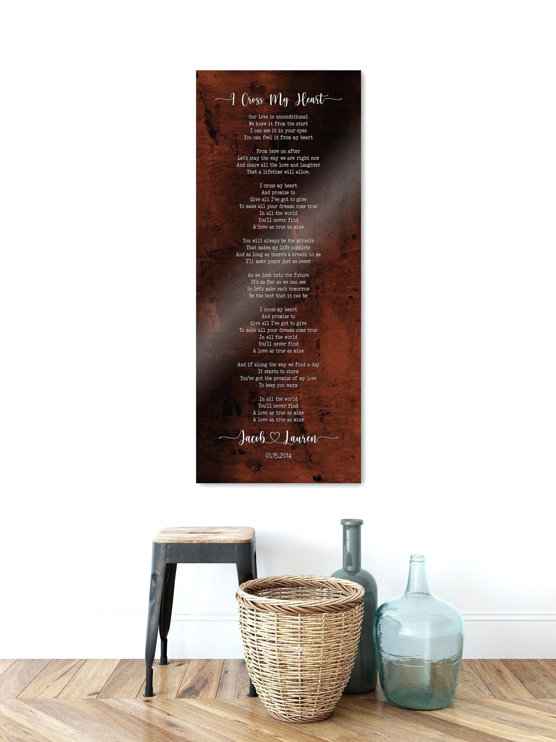 Tall Song Lyric sign on bronze metal, hung on wall above vases, and small bench. This extra tall song lyrics sign on bronze metal is personalized with any song lyrics, names connected by a heart motif and a date. Whimsical font pairing gives it a bohemian feel, set on an organic burnished bronze background.
