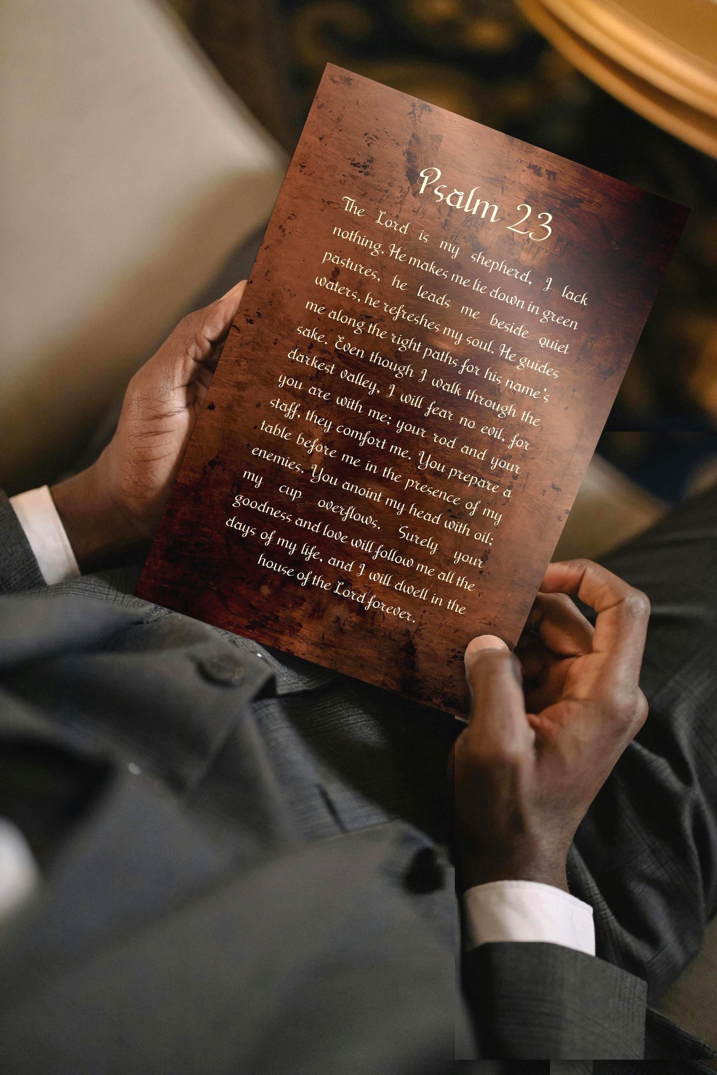 Man holding a Psalm 23 burnished bronzed Metal plaque.  Photo courtesy of Honeycomb Proverbs