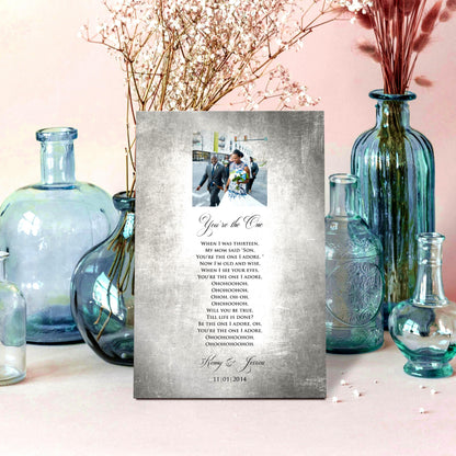 Custom Portrait plaque on tin for couples. Features the song lyrics or wording of choice and a photo cameo above the lyrics. This piece is handcrafted on vintage tin and is displayed with vases on a pale pink background.  Courtesy of Honeycomb Proverbs