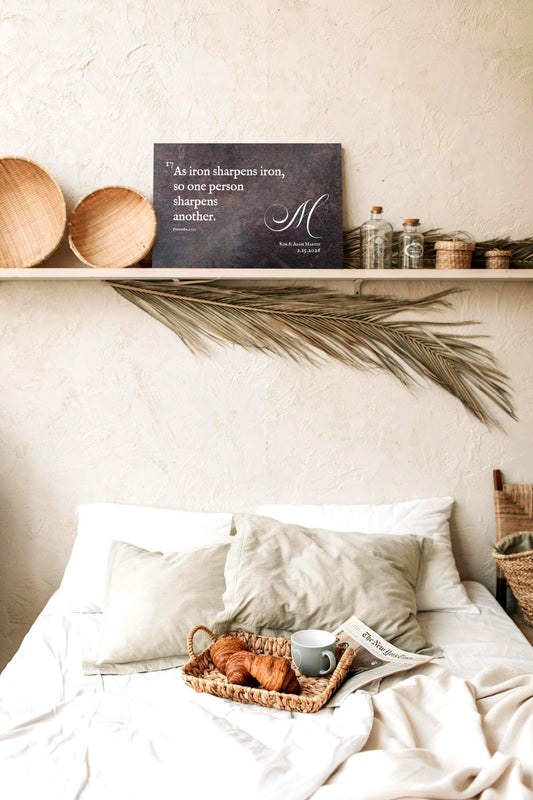 A rustic metal plaque in a rust-cast-iron finish with the words, "As iron sharpens iron, so one person sharpens another." inscribed and personalized with a monogram, a bride and groom's names and their union date.

Photo courtesy of Honeycomb Proverbs