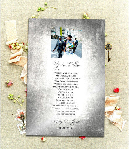 A Vintage, Custom Tin Portrait with song plaque is laid on a linen cloth with sprigs of poppies and brass antique keys. The Tin plaque is tarnished and aged for a vintage styling and features a cameo photo motif at the top of the plate and song lyrics, names and wedding date below. The song title and the couple's names are inscribed with elegant and romantic scripted lettering.  Photo Courtesy of Honeycomb Proverbs