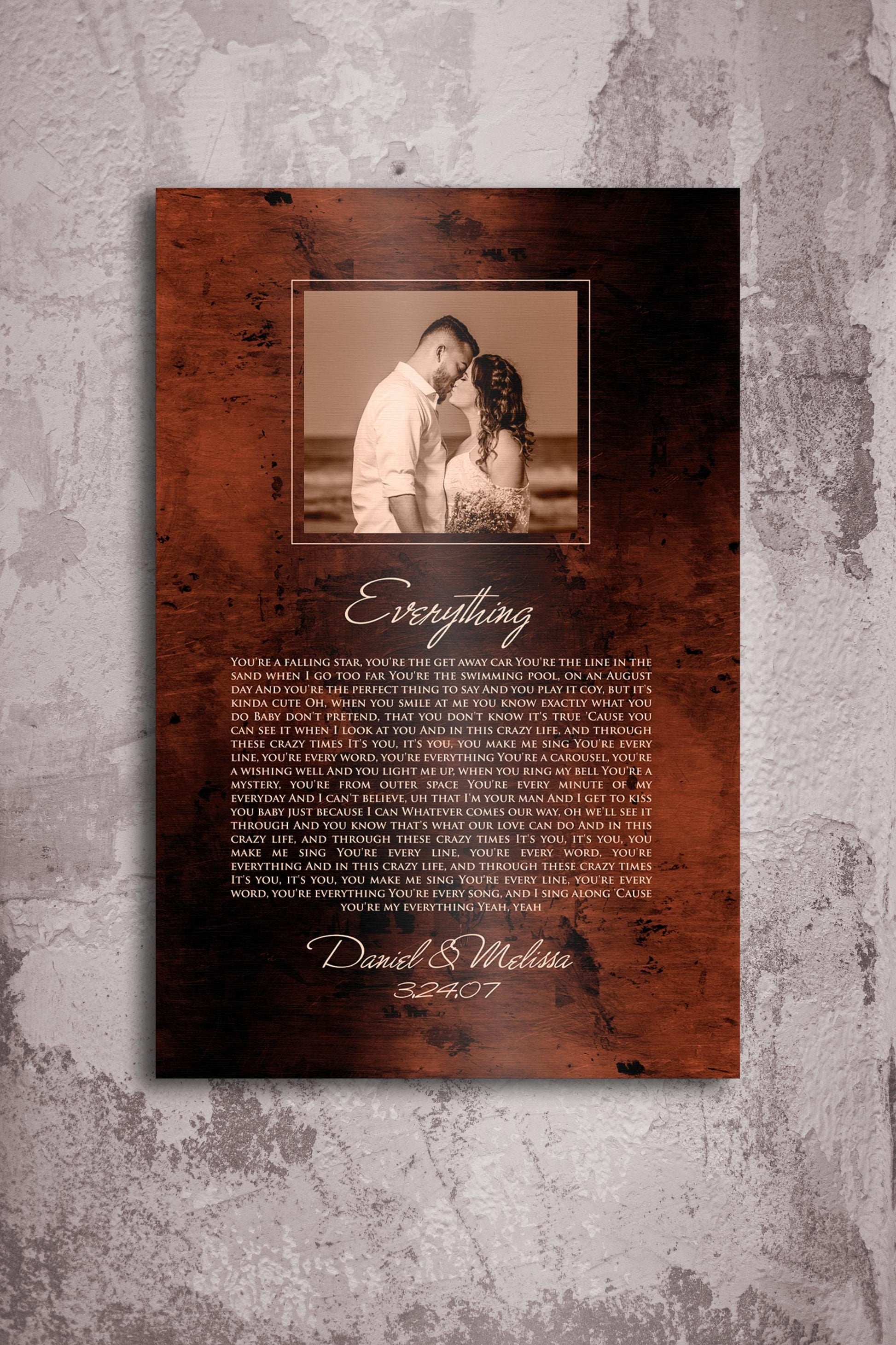 Bronze anniversary song plaque with photo of bride and groom framed at the top of plaque and song lyrics to Everything beneath, followed by their names and wedding date.