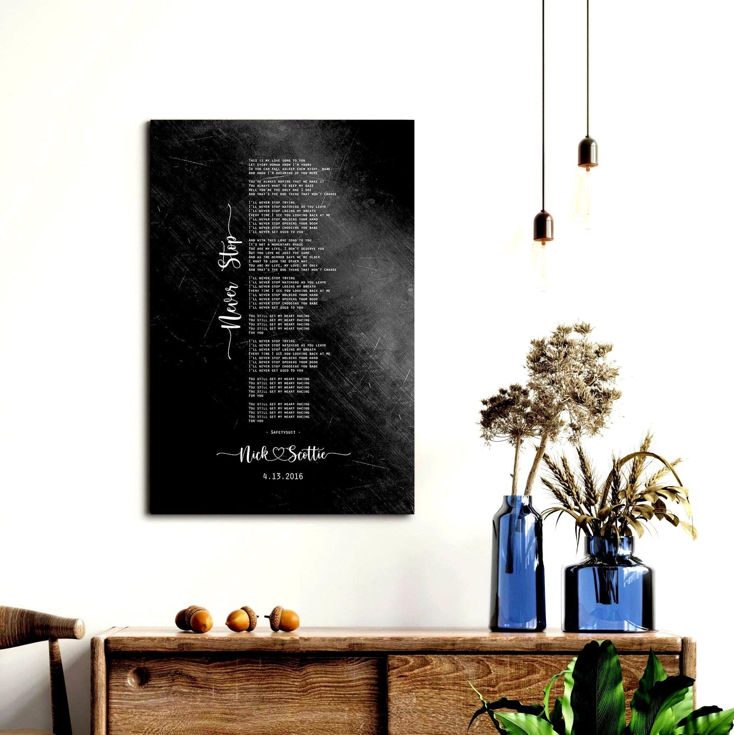 Distressed iron metal wall art personalized with wedding song, the bride and groom's first names connected by a heart, and their special date, hangs on a wall above a cabinet.
