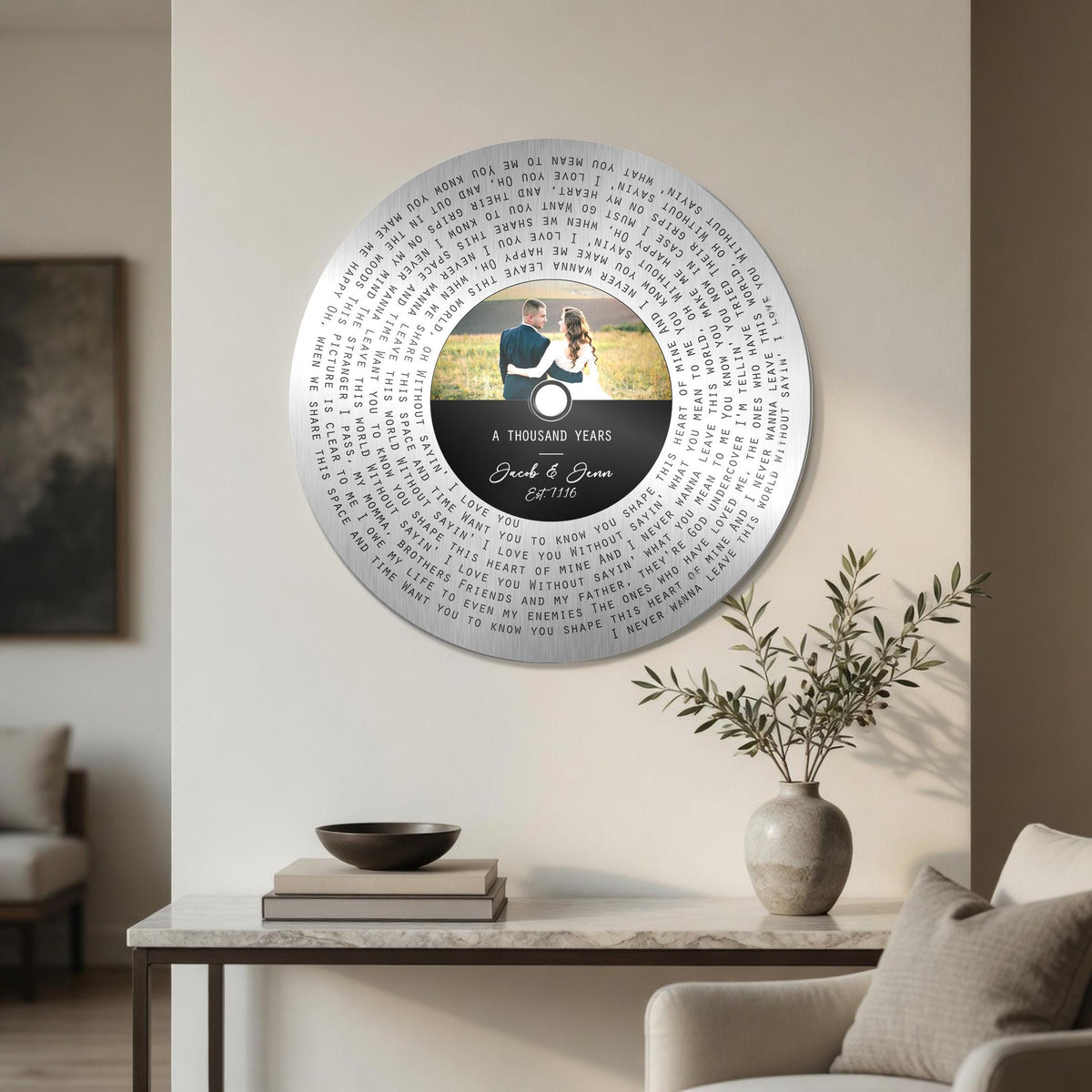 Round tin song lyrics record with personalized photo label, displayed on a shelf in a bright room