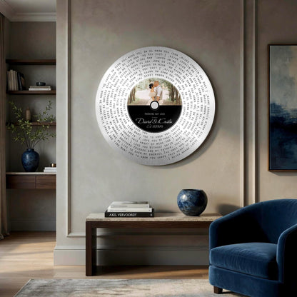 Round tin song lyrics record hanging in a living room above a side table